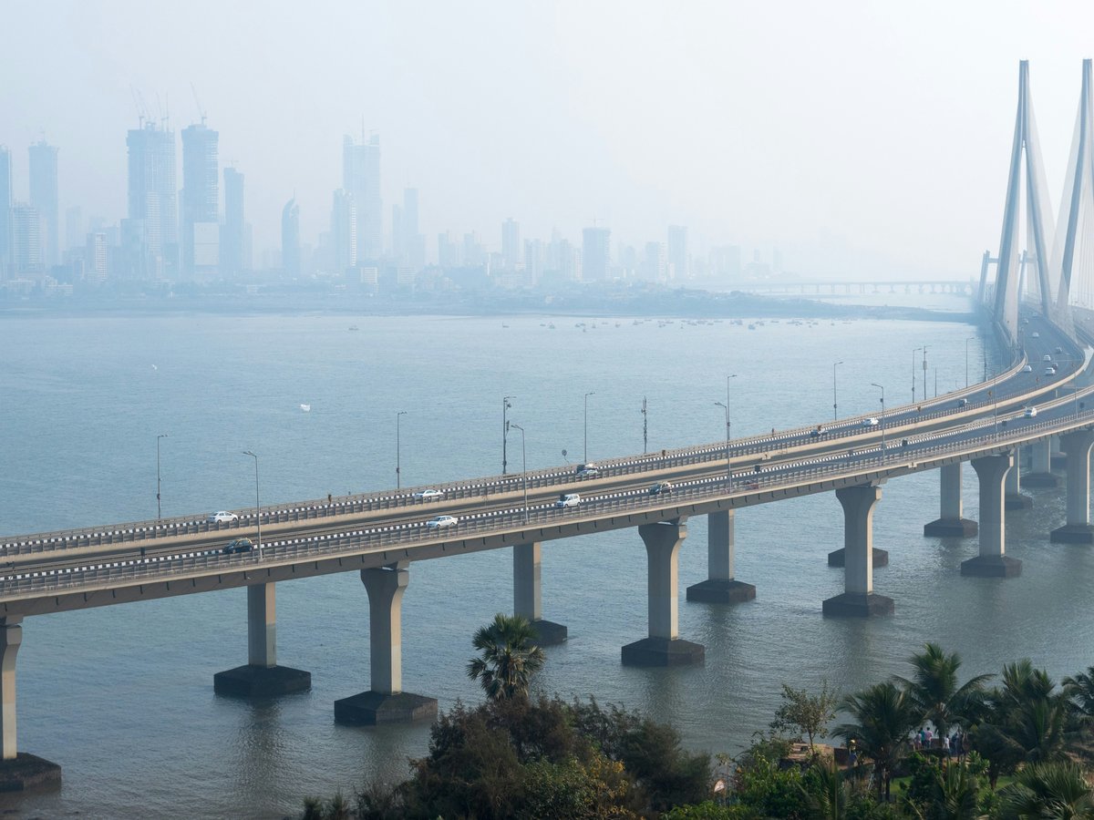 vehicles on cabled-stayed bridge during daytime