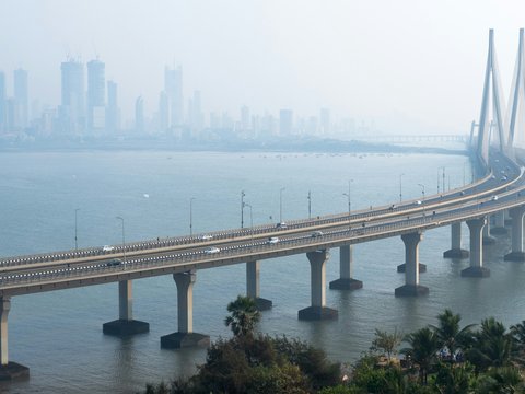 vehicles on cabled-stayed bridge during daytime