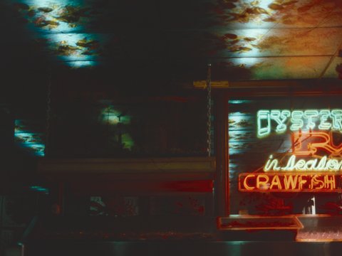 a neon sign that is on the side of a building
