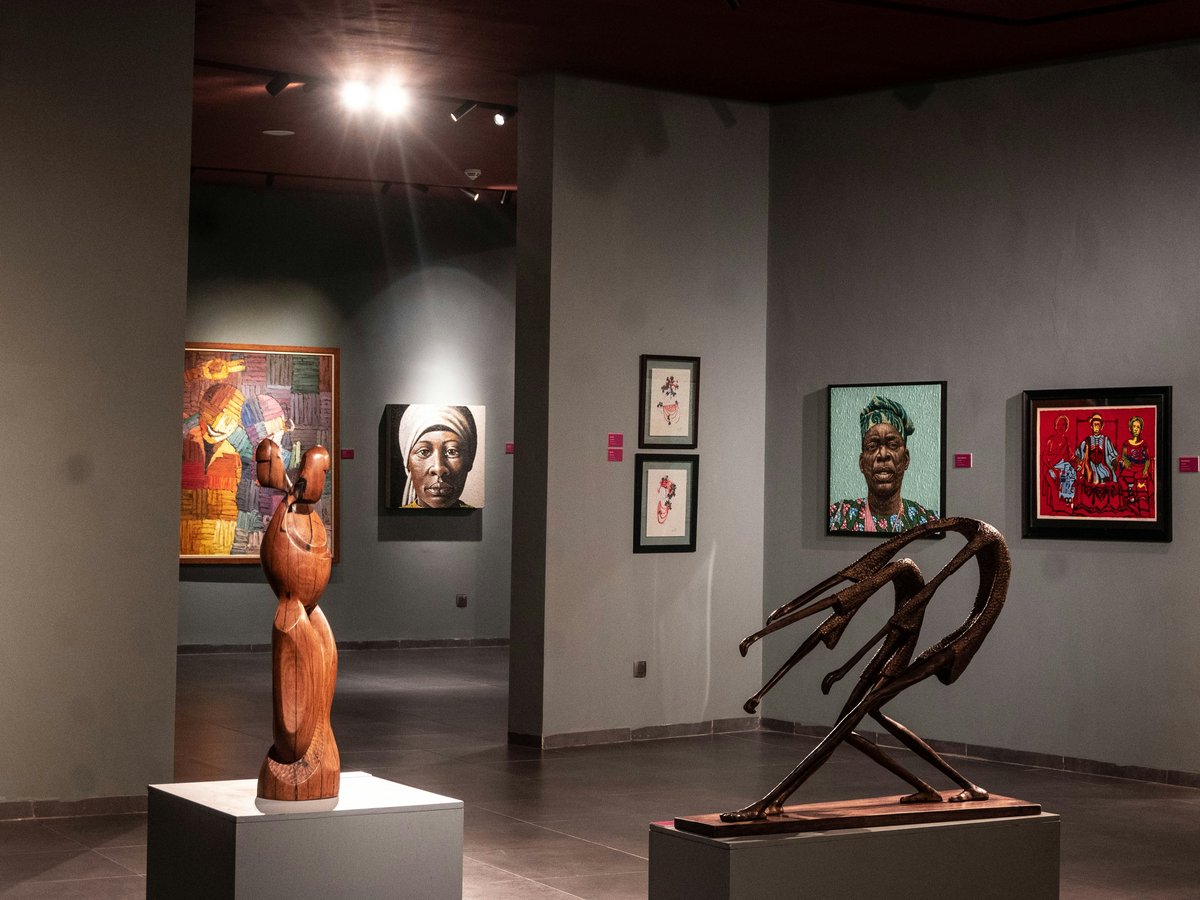 Sculptures and paintings displayed in a museum gallery