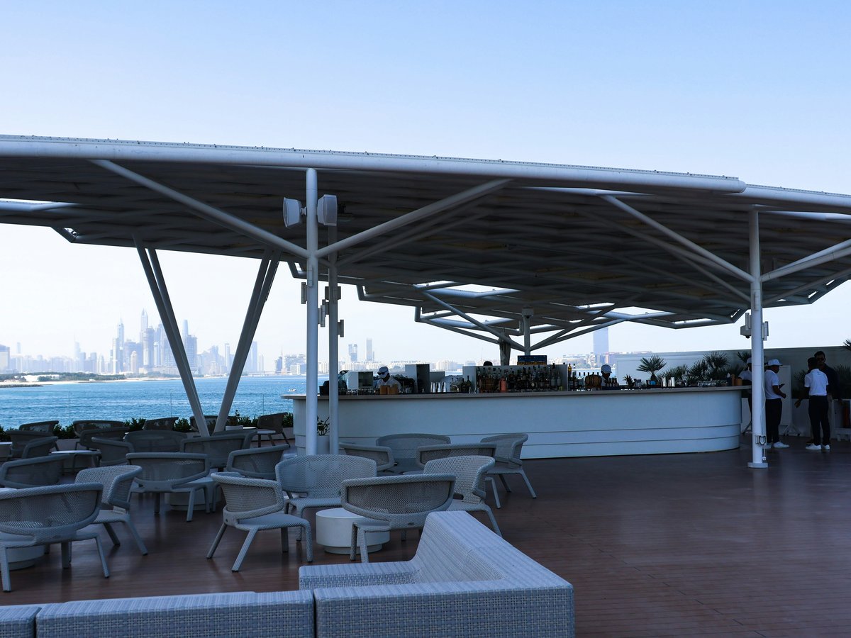 An outdoor restaurant with a city view.