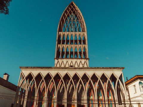 a church with a tall steeple and stained glass windows