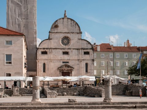 a church with a clock tower in the middle of a town