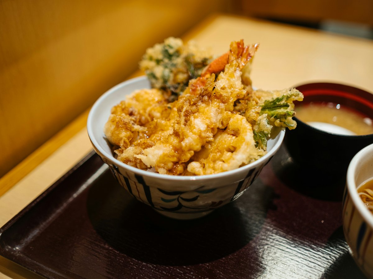 brown rice on white and blue ceramic bowl