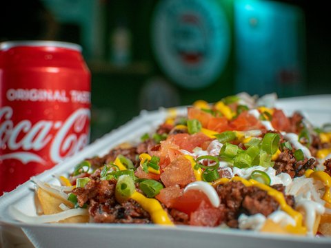 a close up of a tray of food with a can of soda