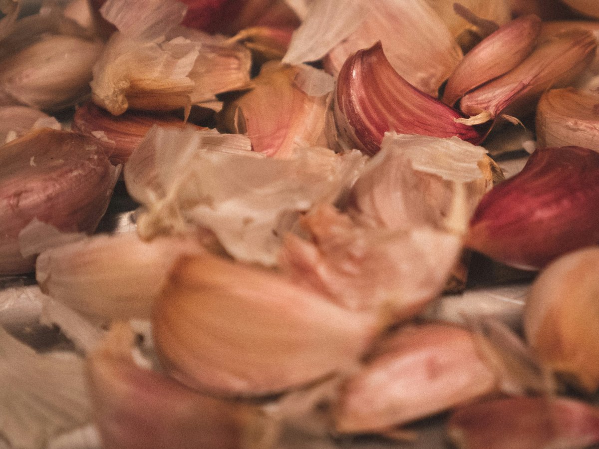 pink and white garlic on white surface
