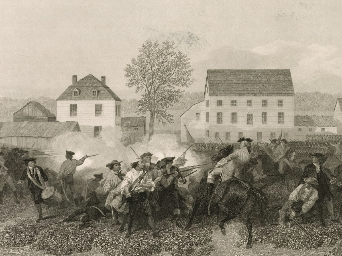 Revolutionary war soldiers in battle near buildings