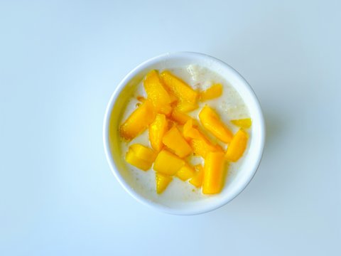 a white bowl filled with fruit on top of a table