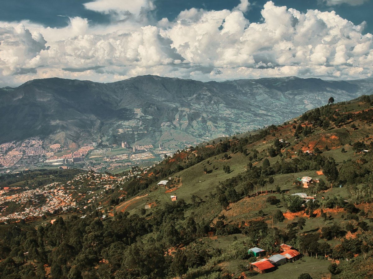 a scenic view of a valley and mountains
