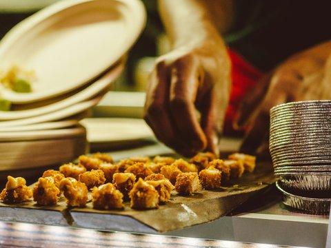 person arranging fried foods