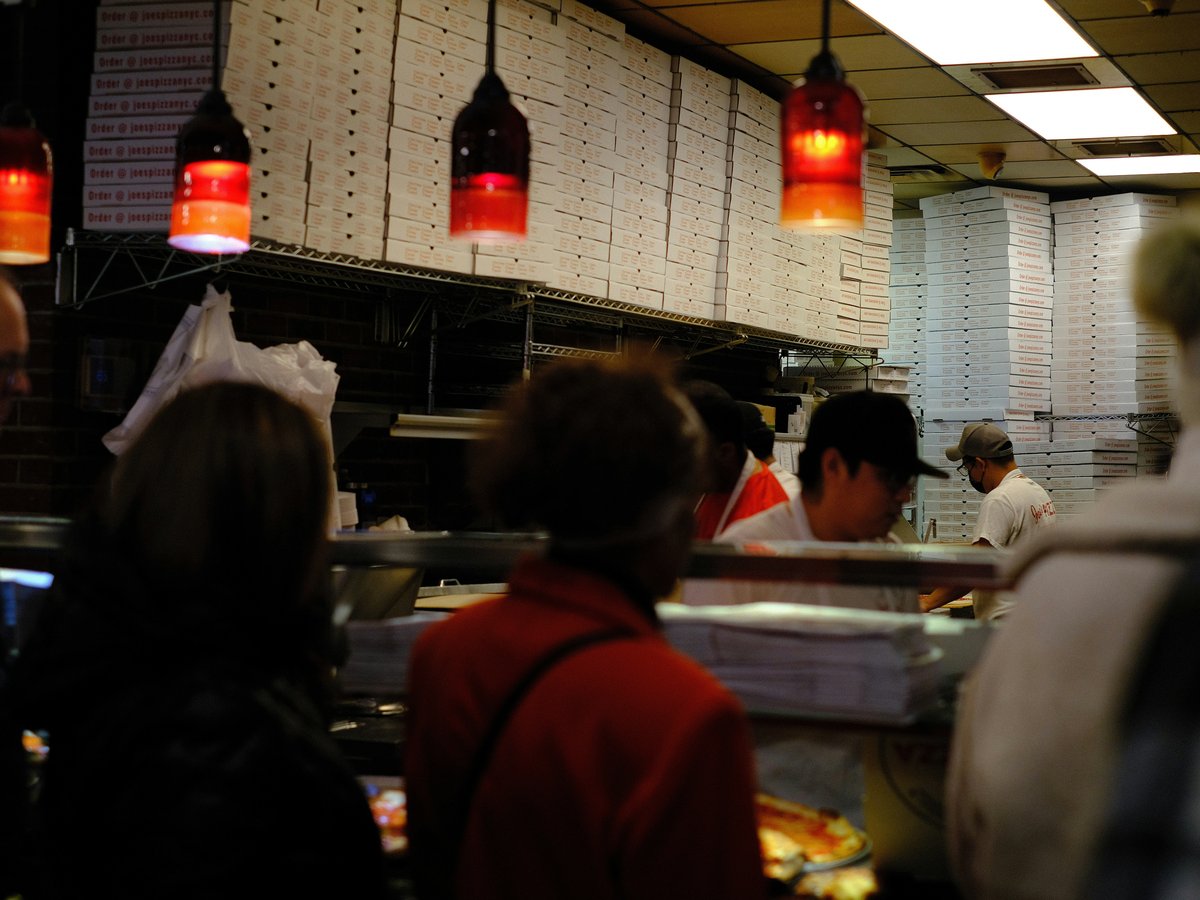 A group of people in a kitchen preparing food