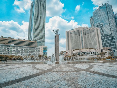 people walking on park near high rise buildings during daytime