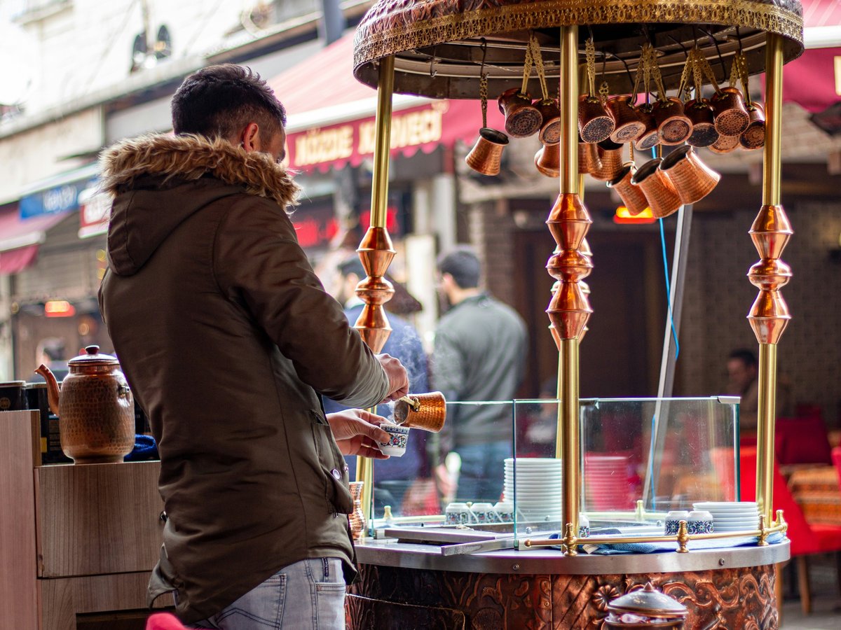 a man standing in front of a food stand