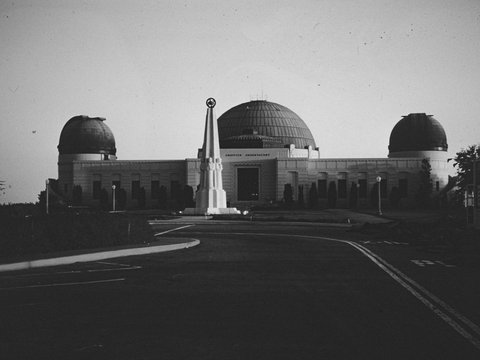 a black and white photo of a building with two domes