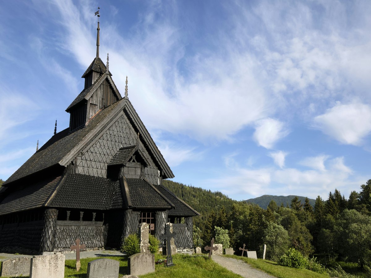 a building with a steeple and trees in the background