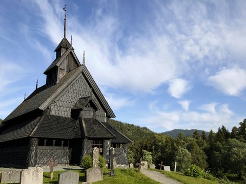 a building with a steeple and trees in the background