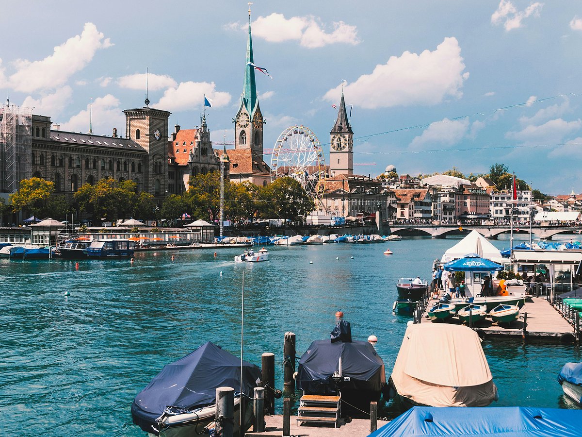 a body of water with boats and buildings in the background