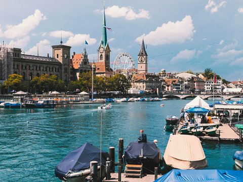 a body of water with boats and buildings in the background