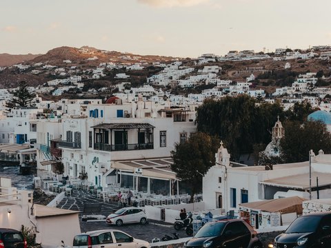 Whitewashed buildings on a hillside overlooking the sea.