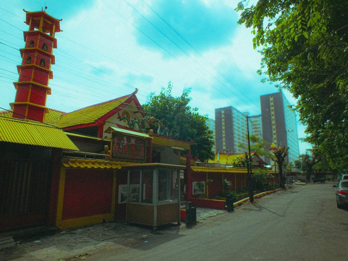 A red and yellow building sitting on the side of a road