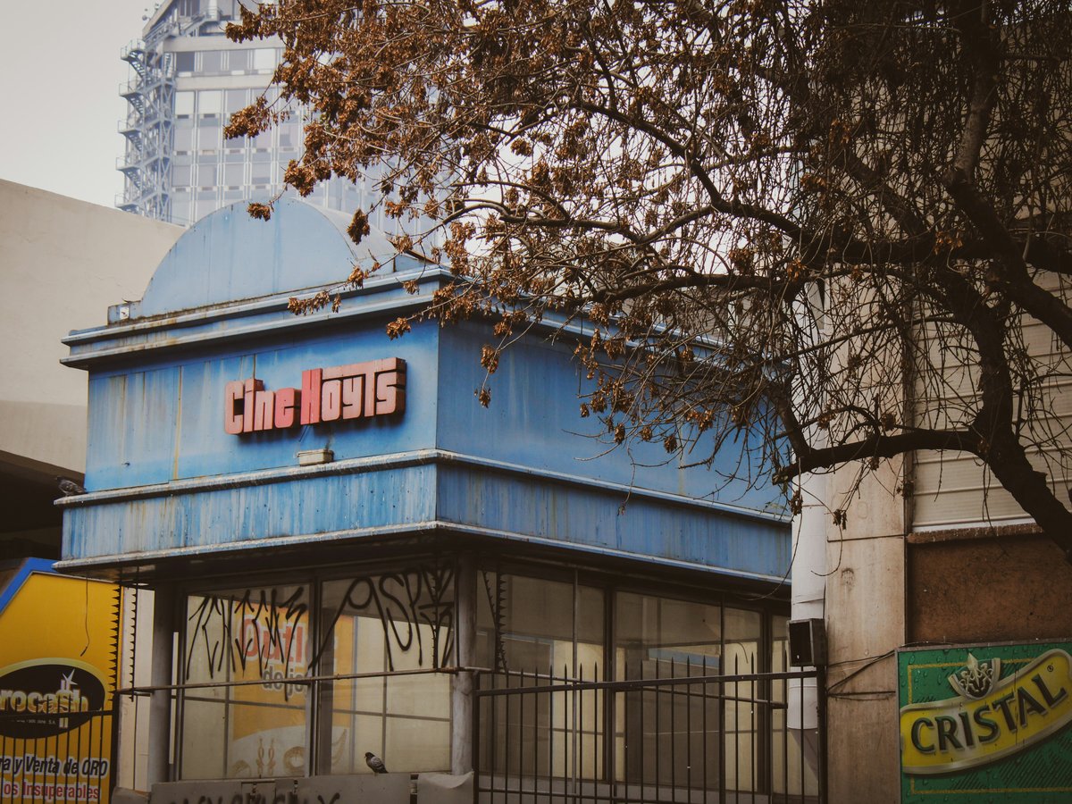 a blue building with a sign on the front of it
