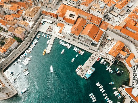 aerial photography of boats on pier and city