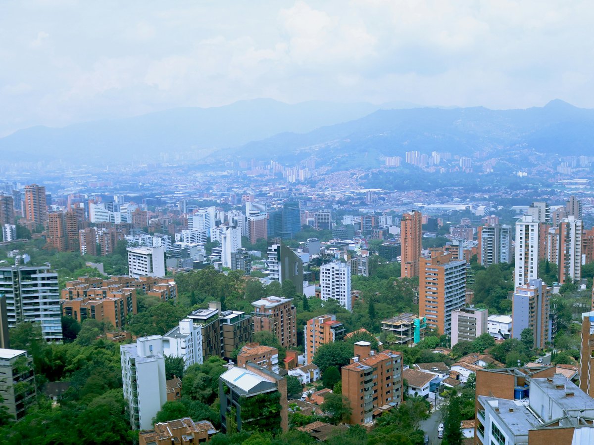 a view of a city with mountains in the background