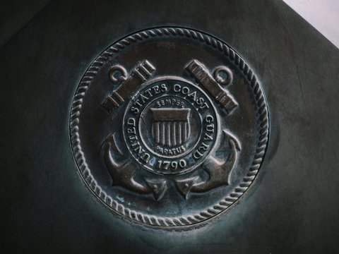 round silver coin on black textile