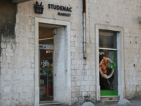 Studenac market storefront on a stone building