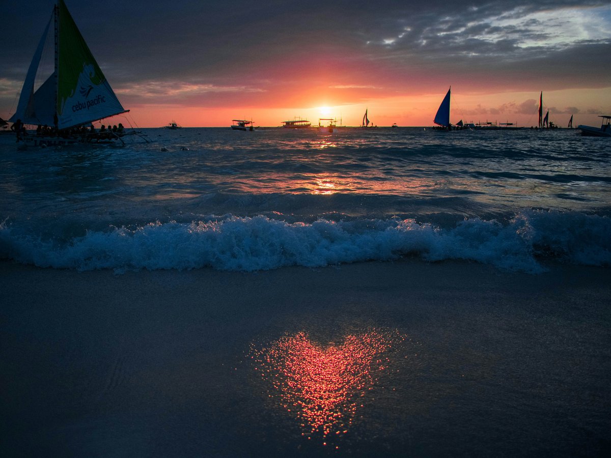 photography of waving water during sunset