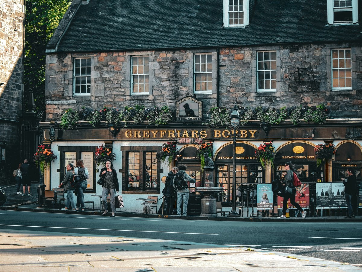 a group of people standing outside of a store