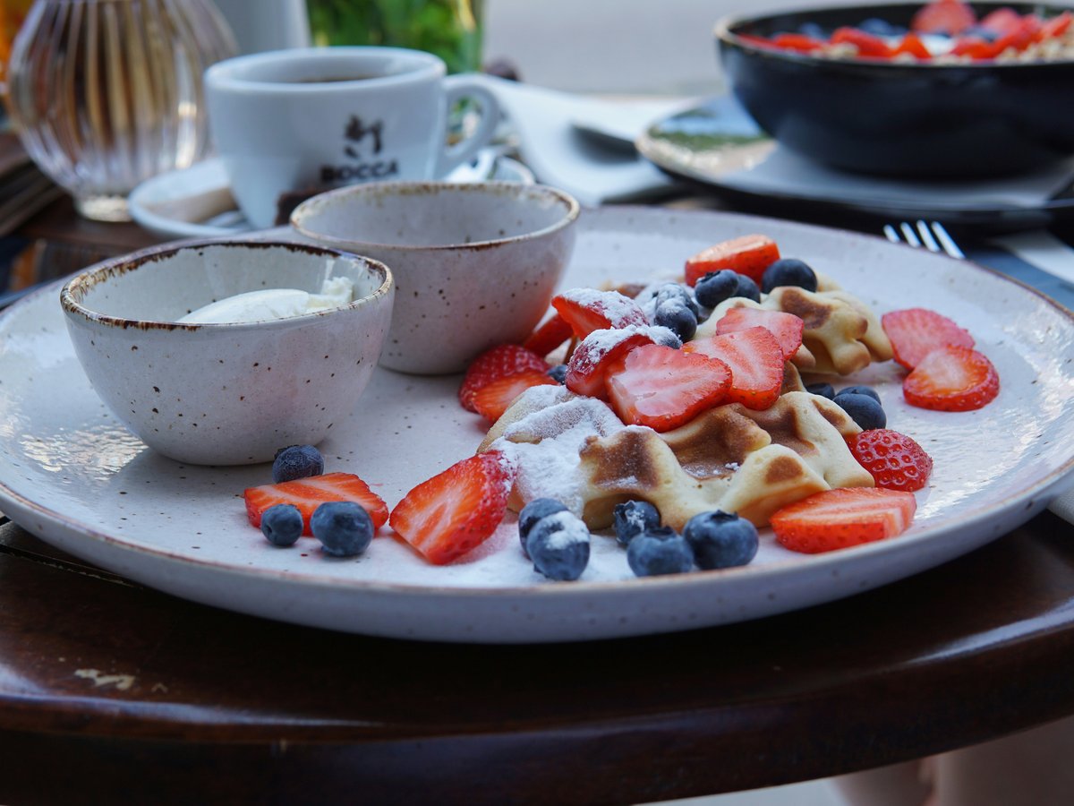 sliced strawberries on white ceramic bowl