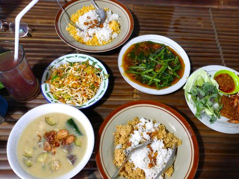 a table topped with plates of food and bowls of soup