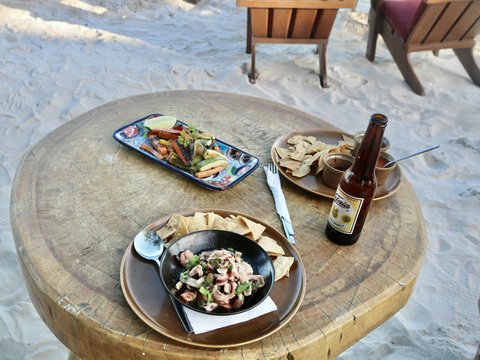 a wooden table topped with a plate of food