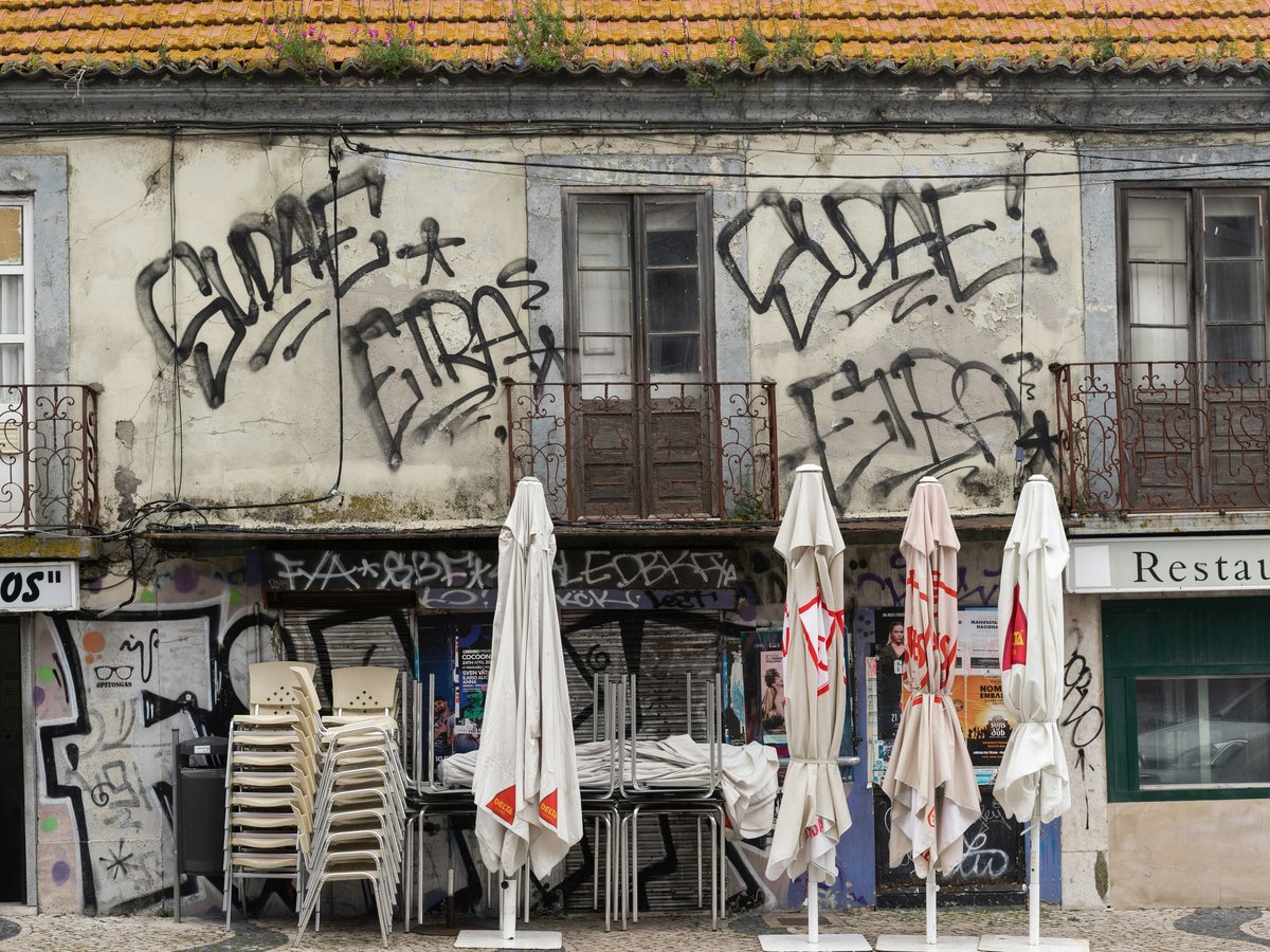 an old building with graffiti on the side of it