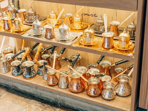a shelf is filled with old pottery