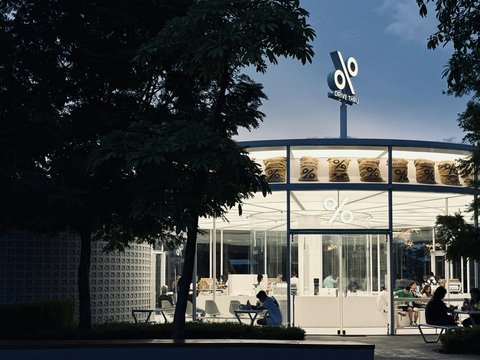 A modern coffee shop glows at dusk