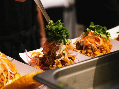 a person cutting food on a plate with a knife