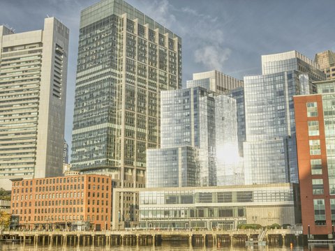 a group of tall buildings next to a body of water